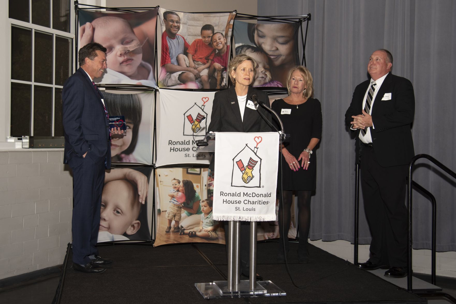 Deb Vogt introduces Ronald McDonald House Charities of St. LouisÕ Cornerstone Society Individual Award winners Mark and Mary Kohlberg. Also pictured is Dan Harbaugh, President.